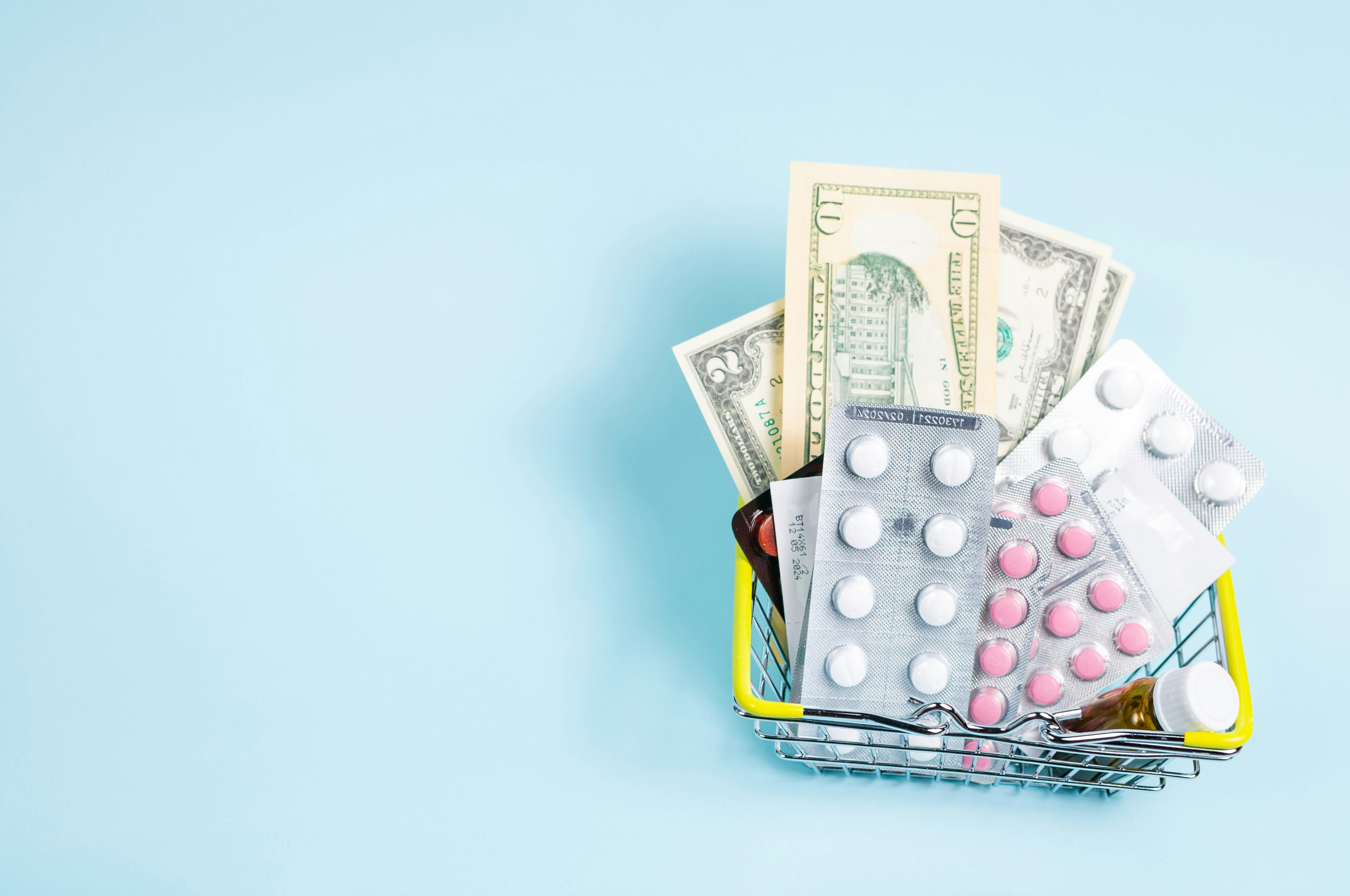 basket of paper bills and medications